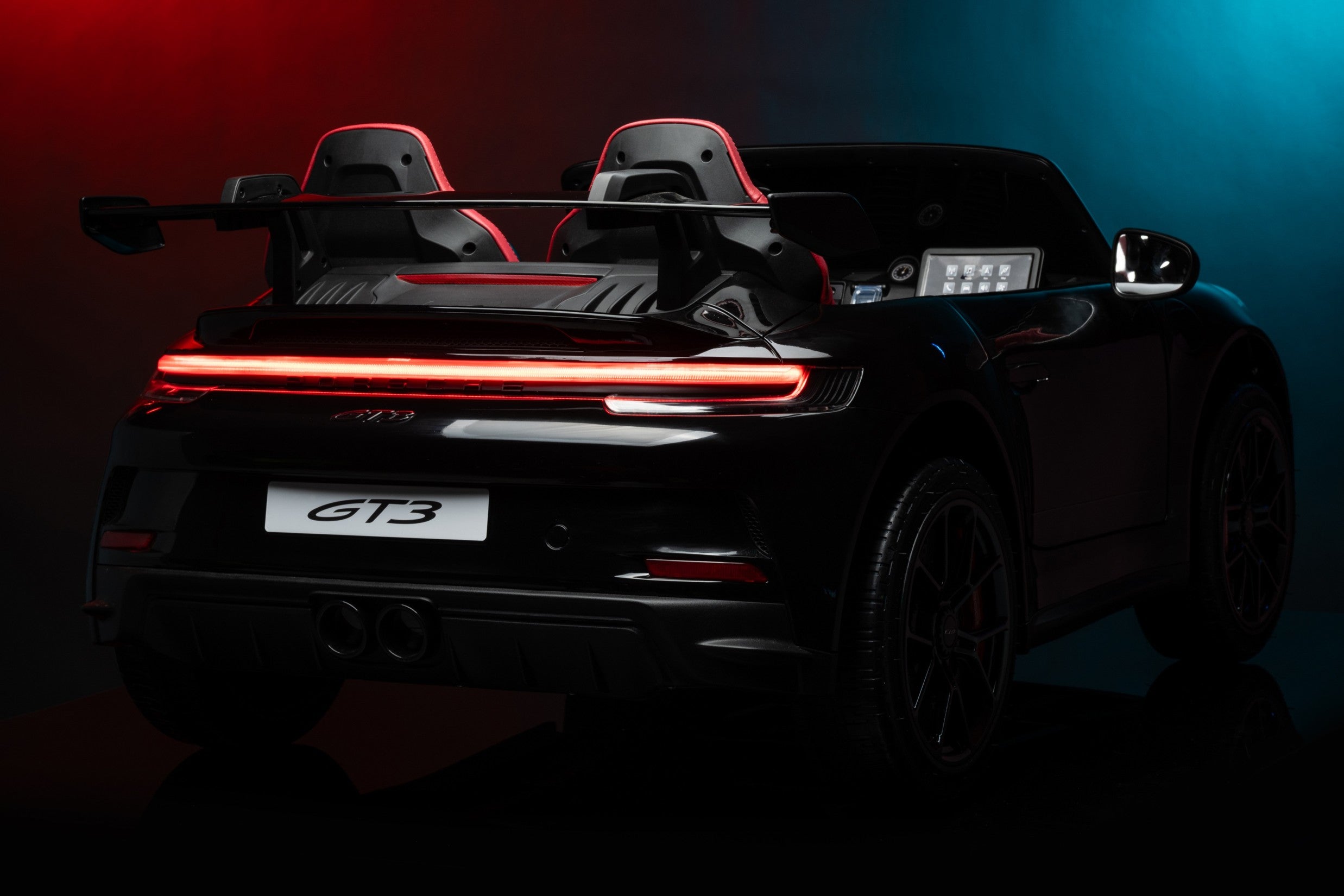 Back view of a black sports car with 'GT3' model badge on a dark background