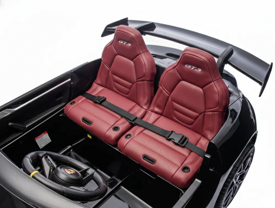 Red car seats with 'GT' logo in a black car interior