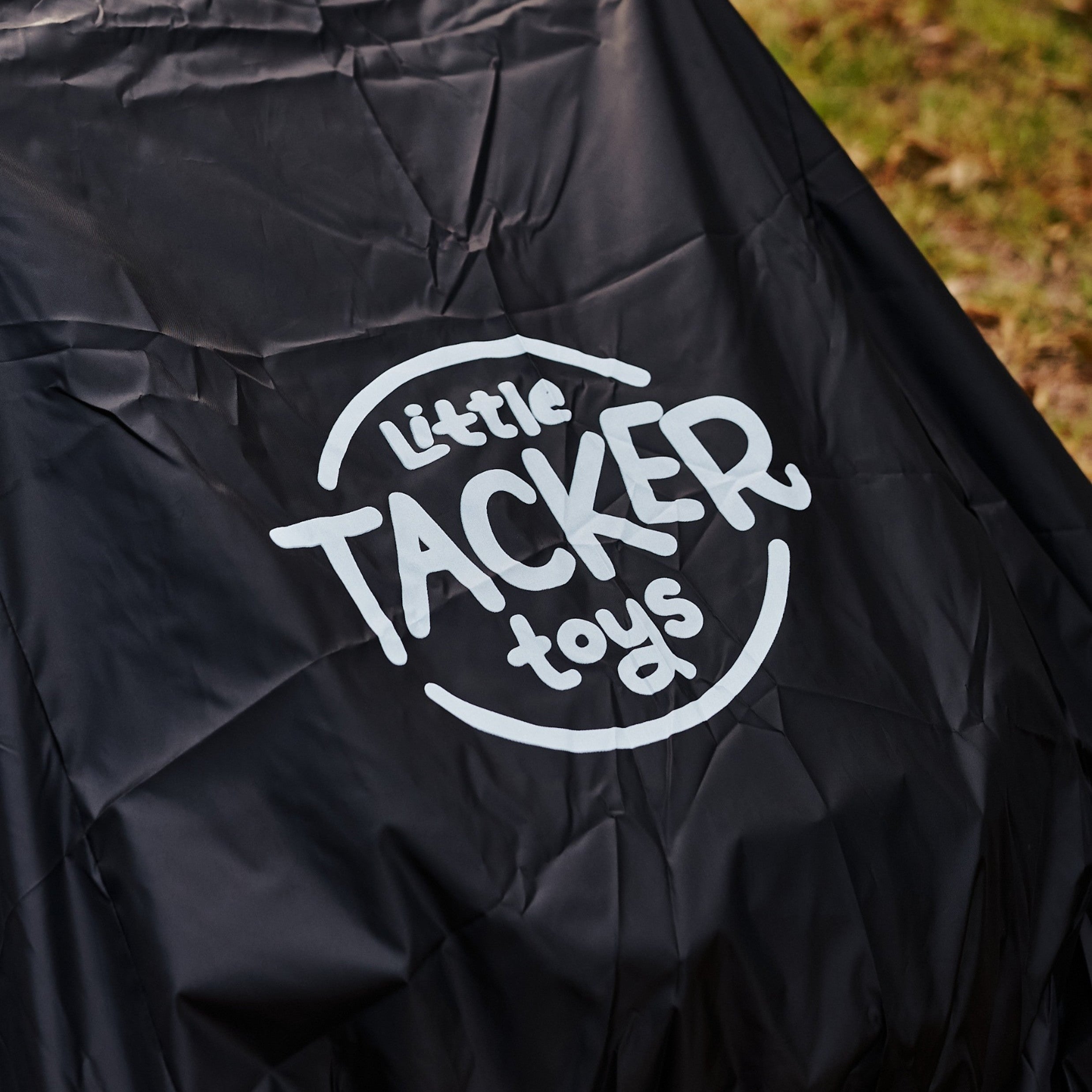 Black cover with 'Little Tacker Toys' logo on a grassy background