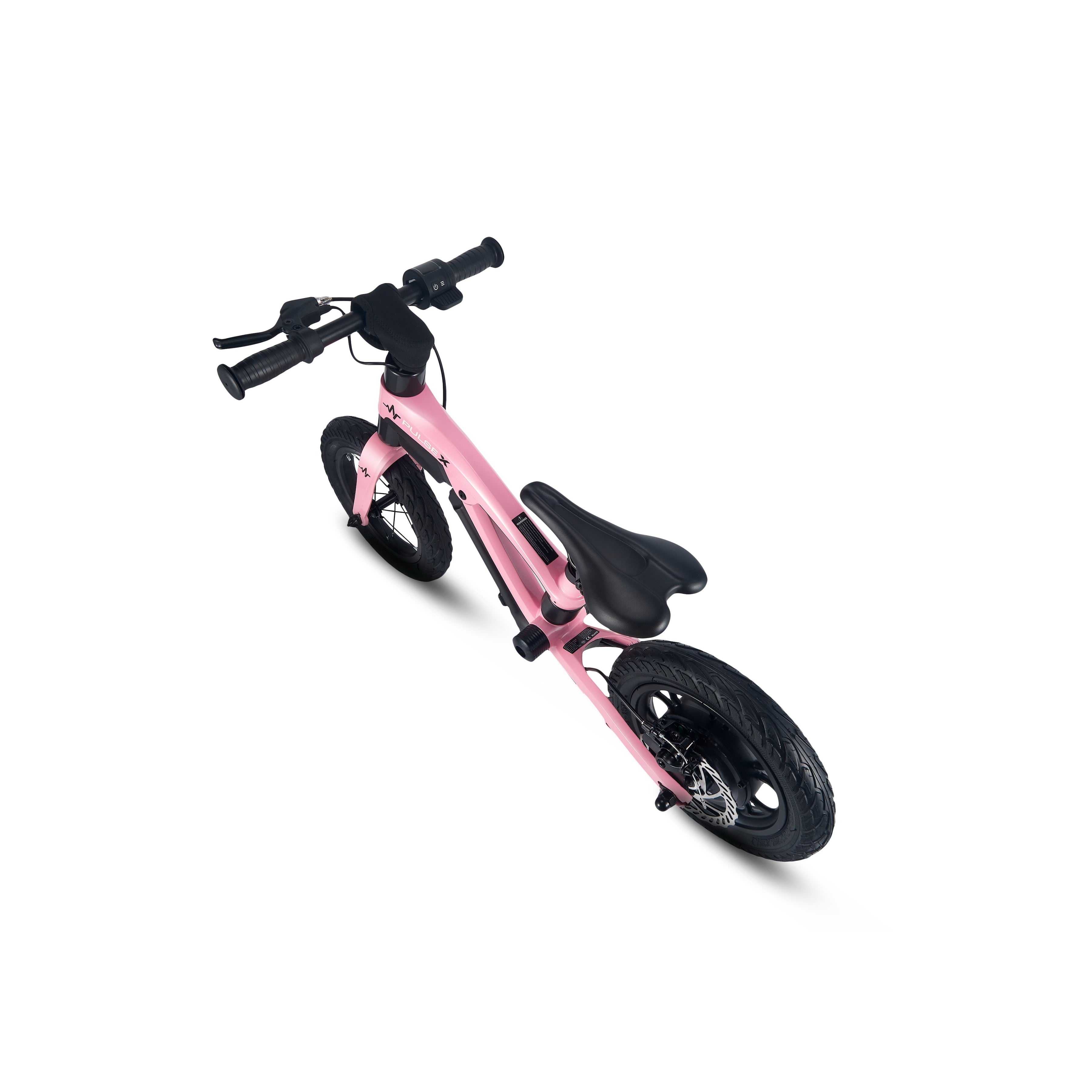 Pink balance bike on a white background