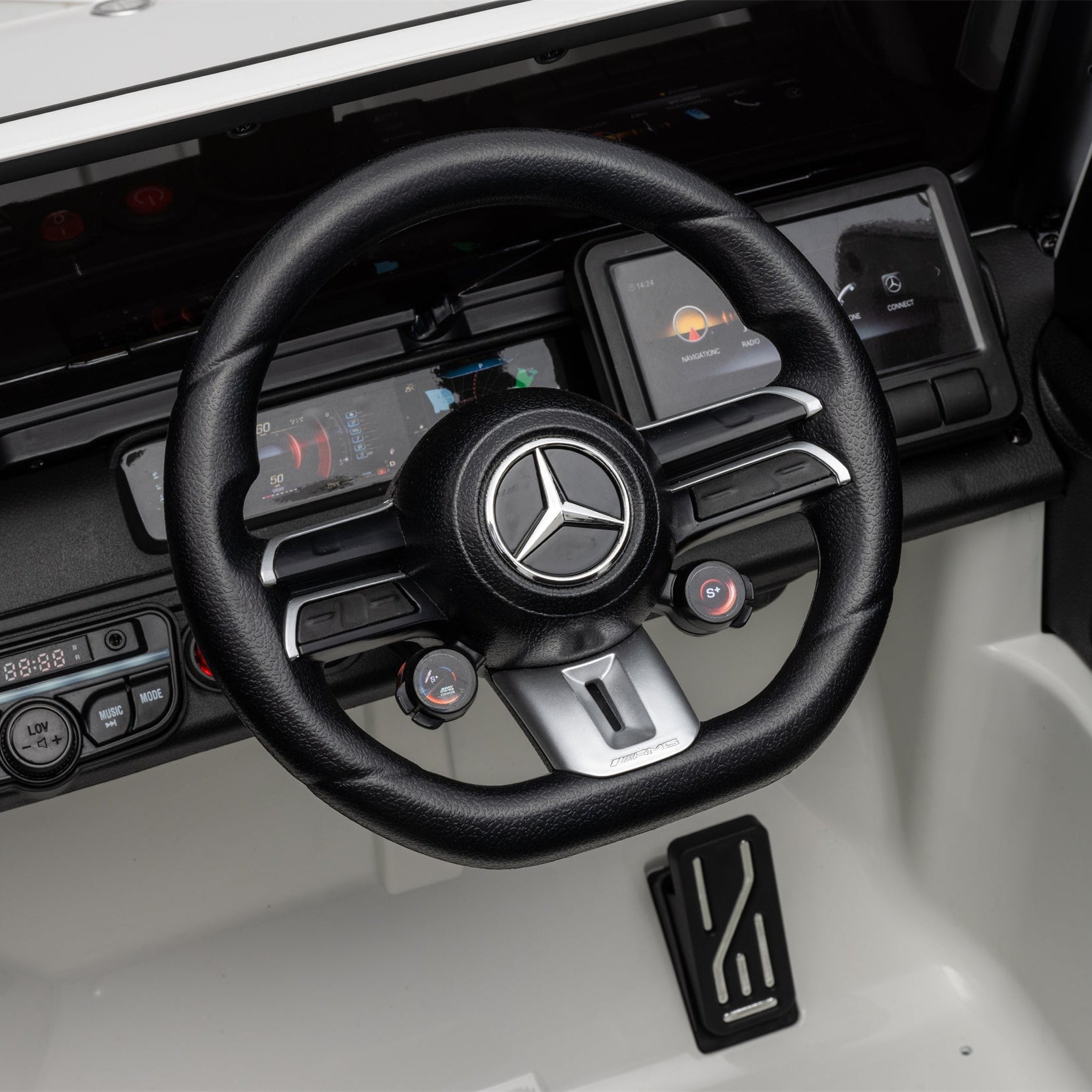 Close-up of a black steering wheel with a Mercedes-Benz logo, mounted in a white and black vehicle interior.