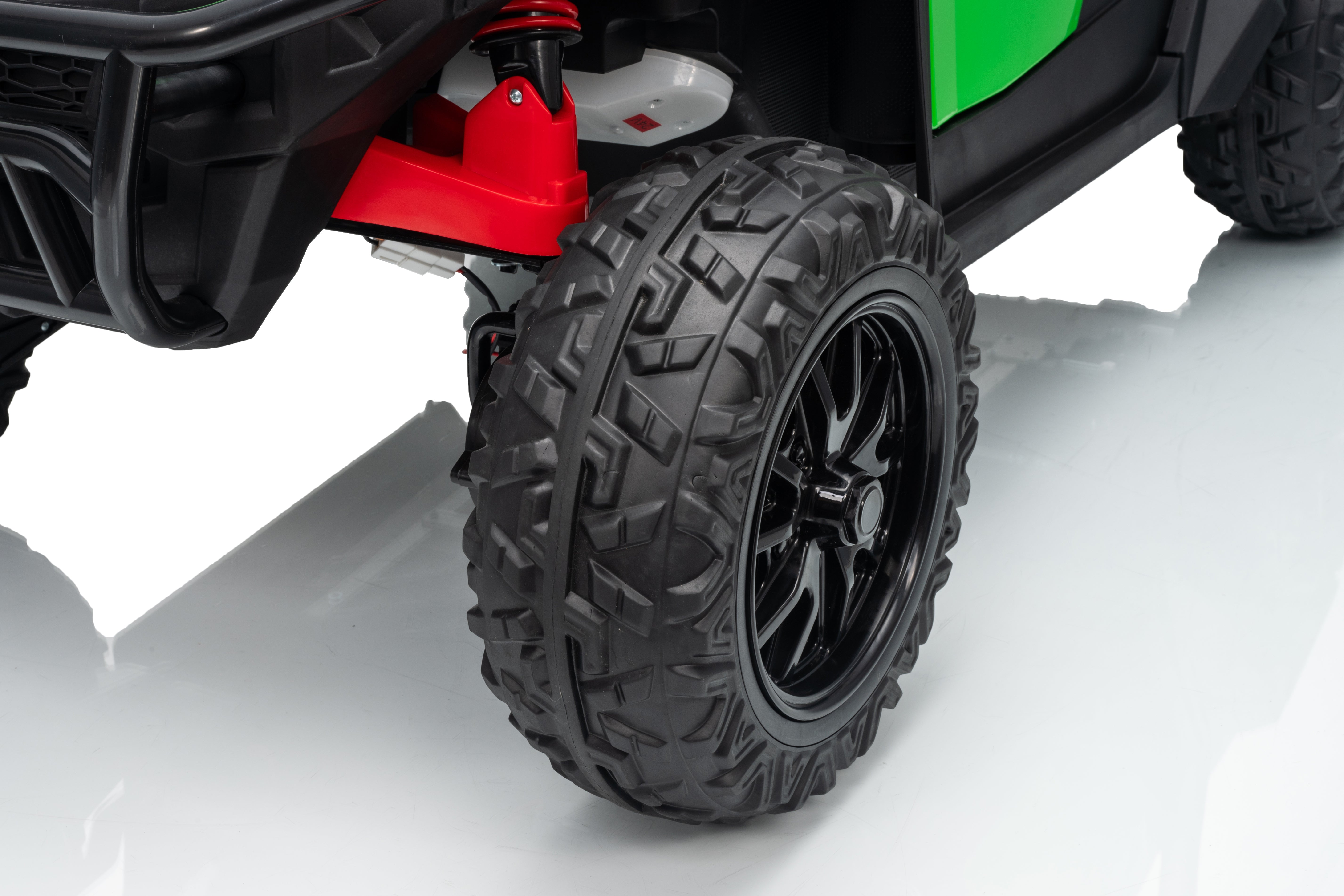 Close-up of a vehicle tire with a red suspension component on a white background