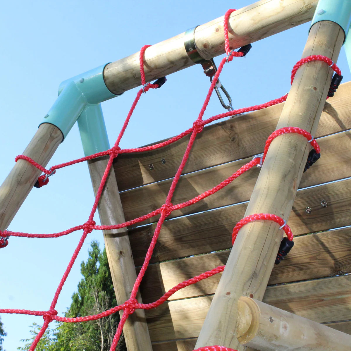 Wooden swing climbing wall with red climbing net. Blue net swing