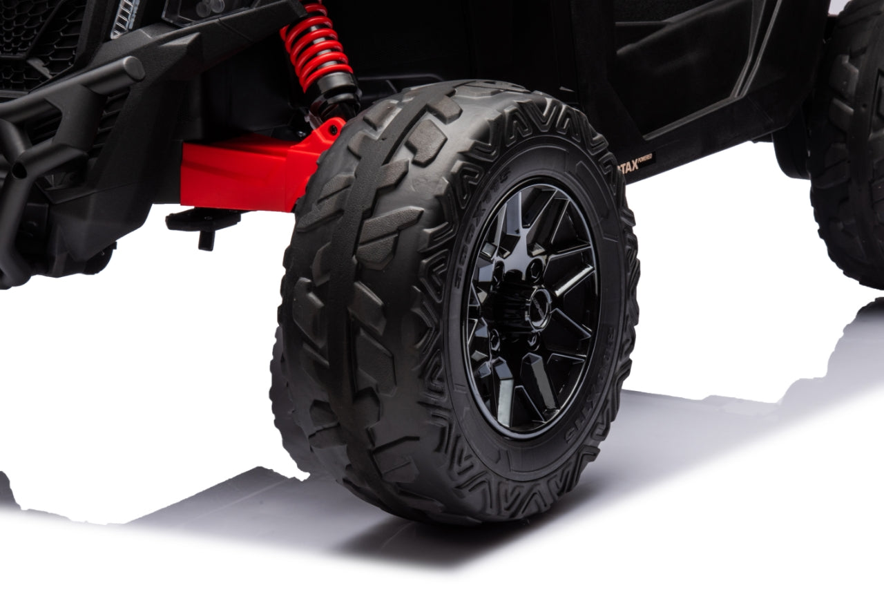 Close-up of a black off-road vehicle tire with red suspension components on a white background