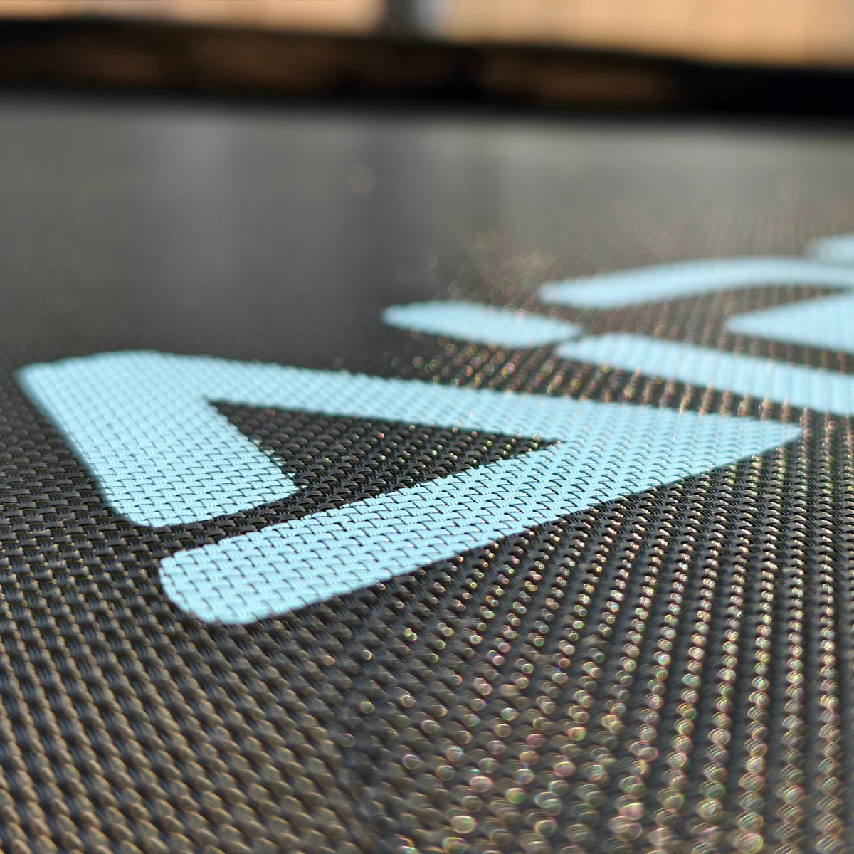 Close-up of a textured surface with a logo or brand name.