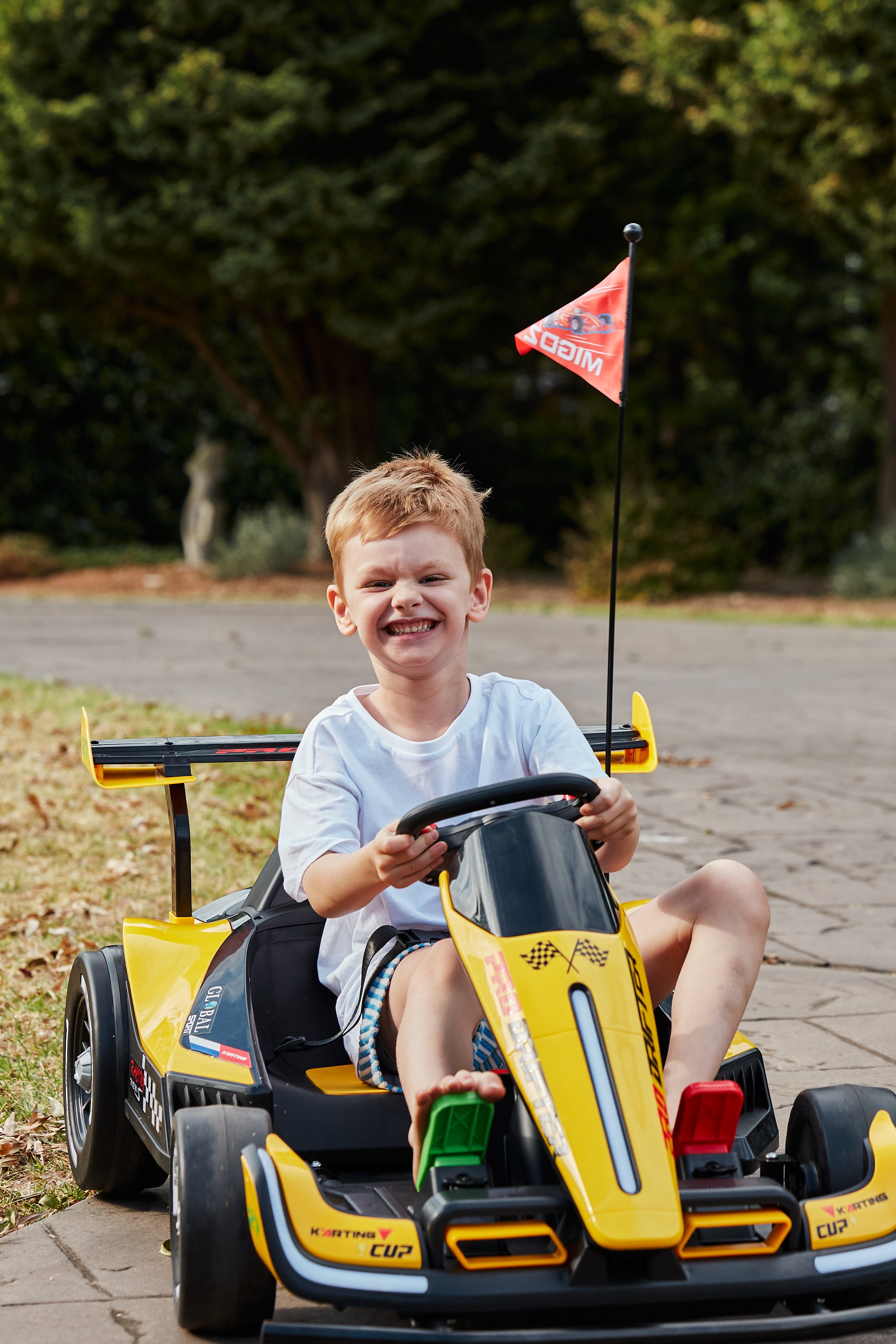 happy child driving go kart