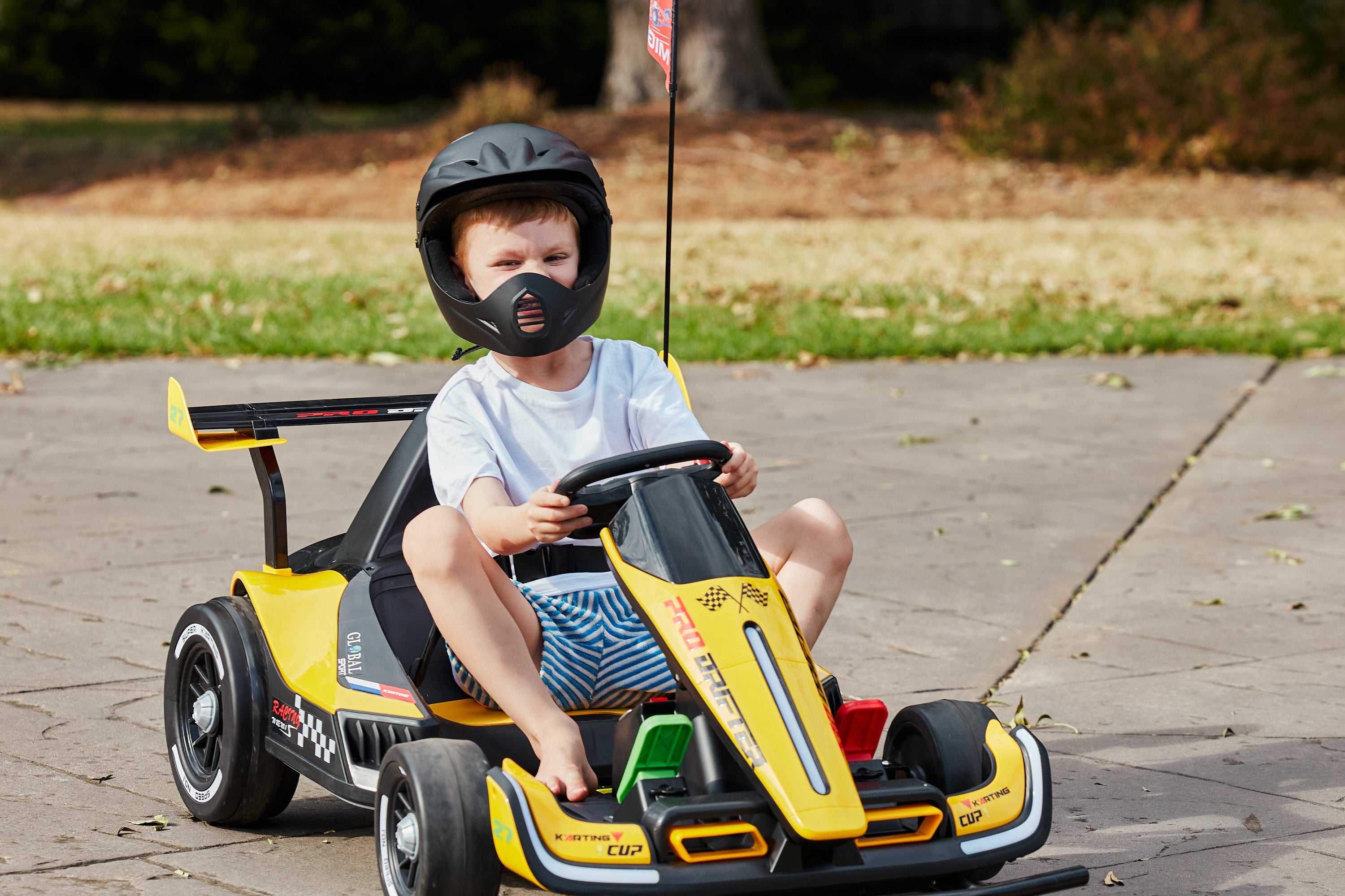 live photo of child driving the go kart