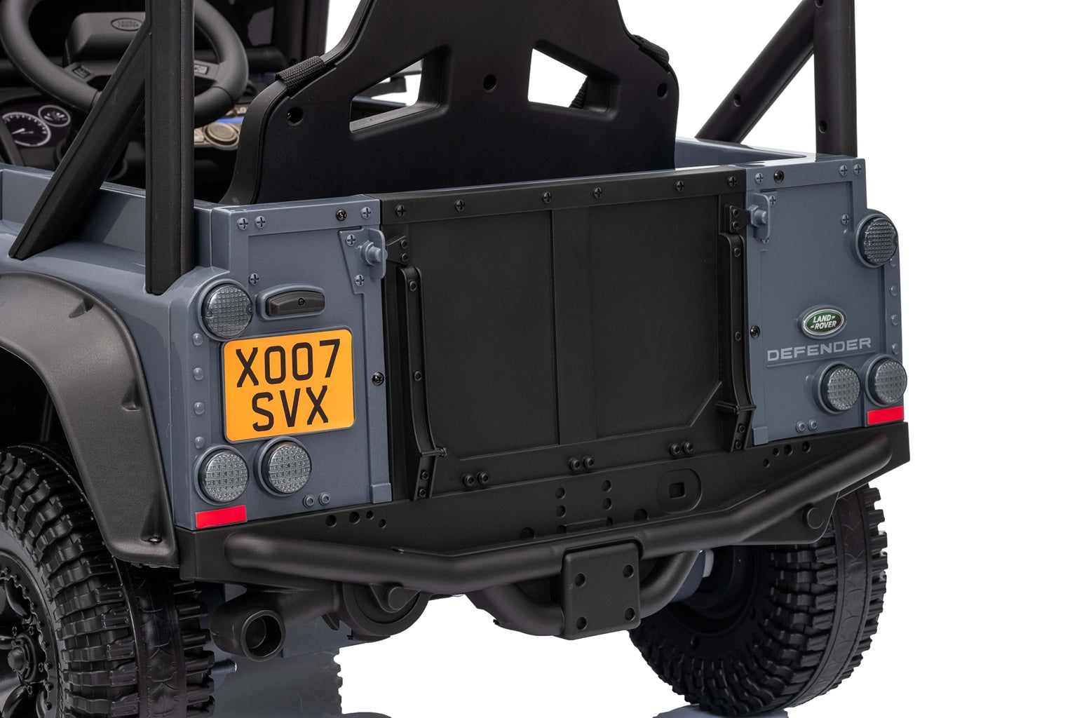 Rear view of the licensed Land Rover Defender ride-on car with open doors and detailed tail lights