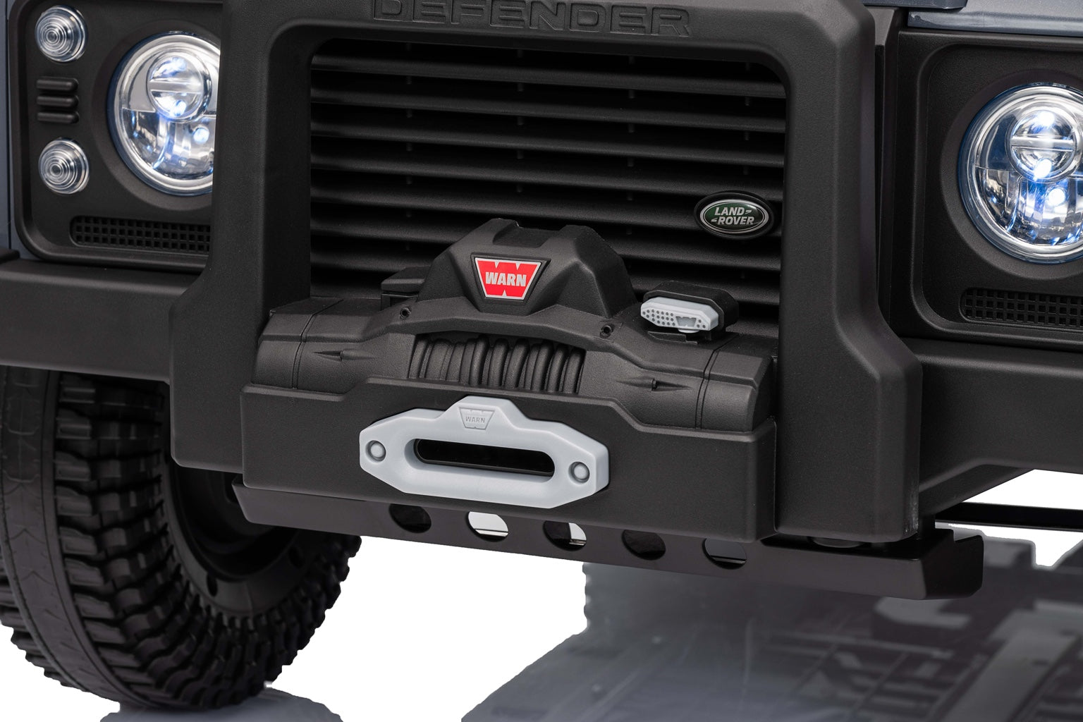 Close-up of the rugged front bumper and winch on the Land Rover Defender ride-on kids electric car.