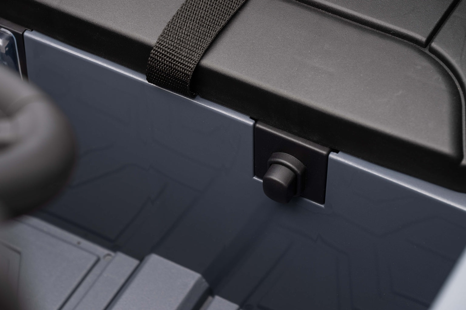 Close-up of the seatbelt and interior detailing inside the Land Rover Defender kids ride-on car.