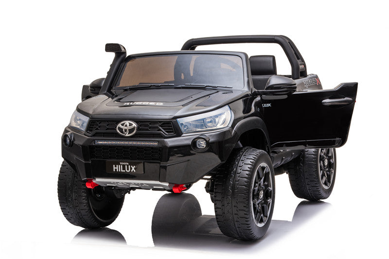 Front view of the Toyota Hilux Rugged X kids’ ride-on with both doors open, highlighting realistic styling.