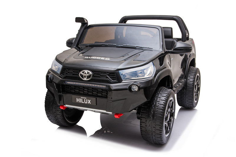 Front view of the Toyota Hilux 4WD kids’ electric ride-on with illuminated LED headlights and light bar.