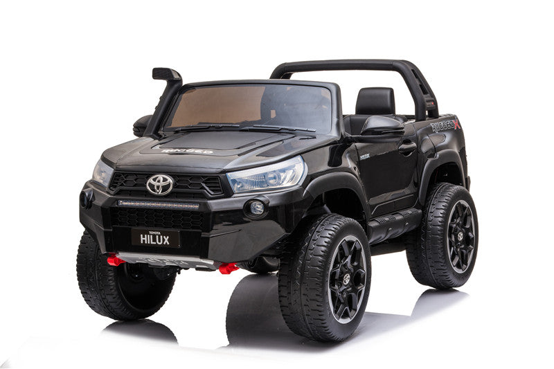 Front-right perspective of the Toyota Hilux 4WD kids’ electric ride-on highlighting off-road wheels and bumper