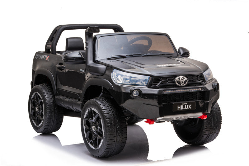 Front-left view of the Toyota Hilux kids’ electric 4WD with headlights and bull bar details.