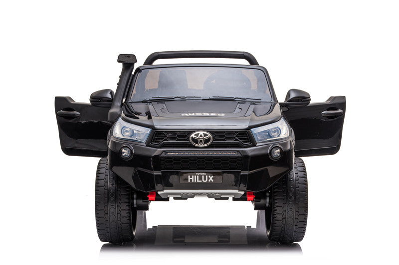 Front view of the Toyota Hilux Rugged X kids’ ride-on with both doors open, highlighting realistic styling.