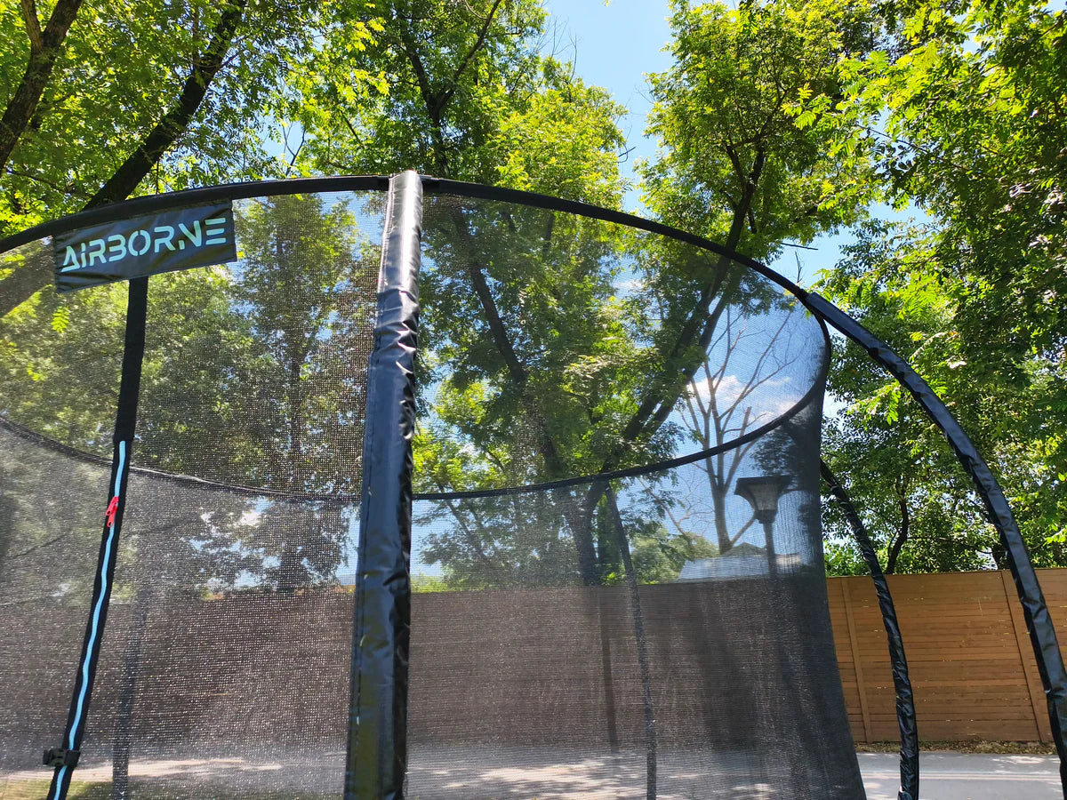 Trampoline with 'Airborne' branding in a park setting