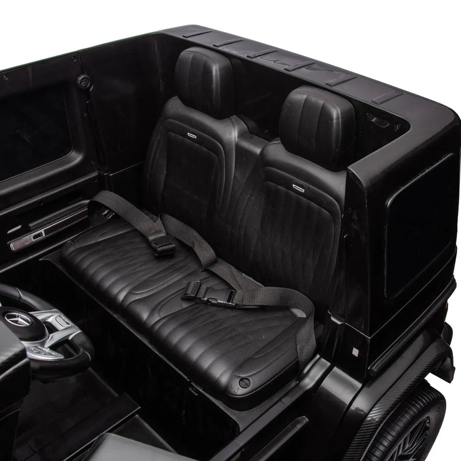 Black electric vehicle interior with seats and dashboard on a white background