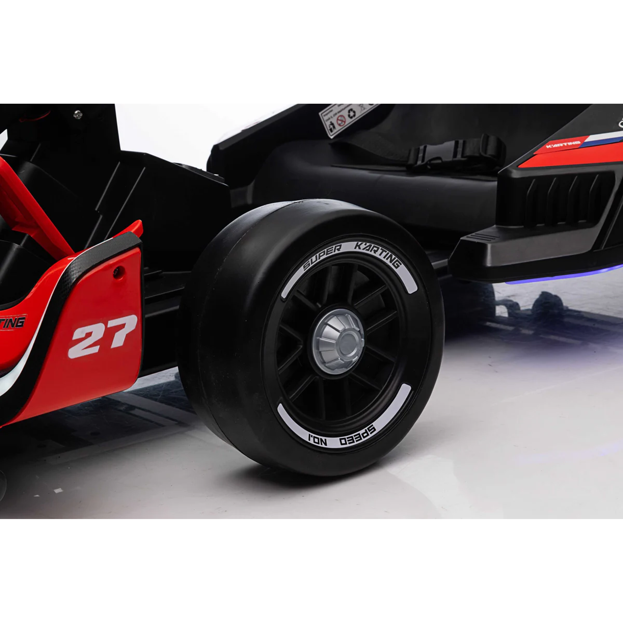 Close-up of a black racing car tire with red and white accents on a white background