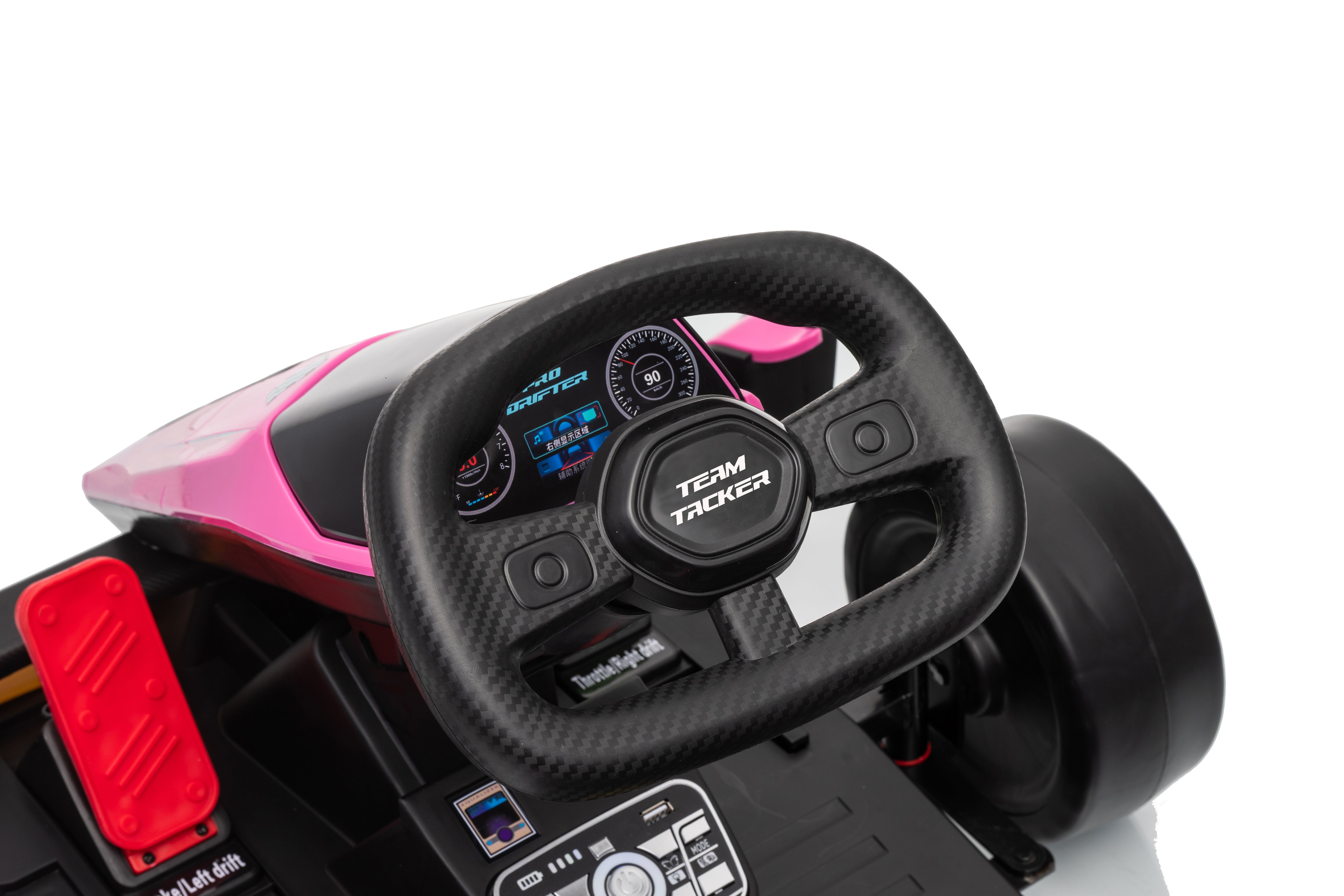 Close-up of a toy car steering wheel with digital display on a white background