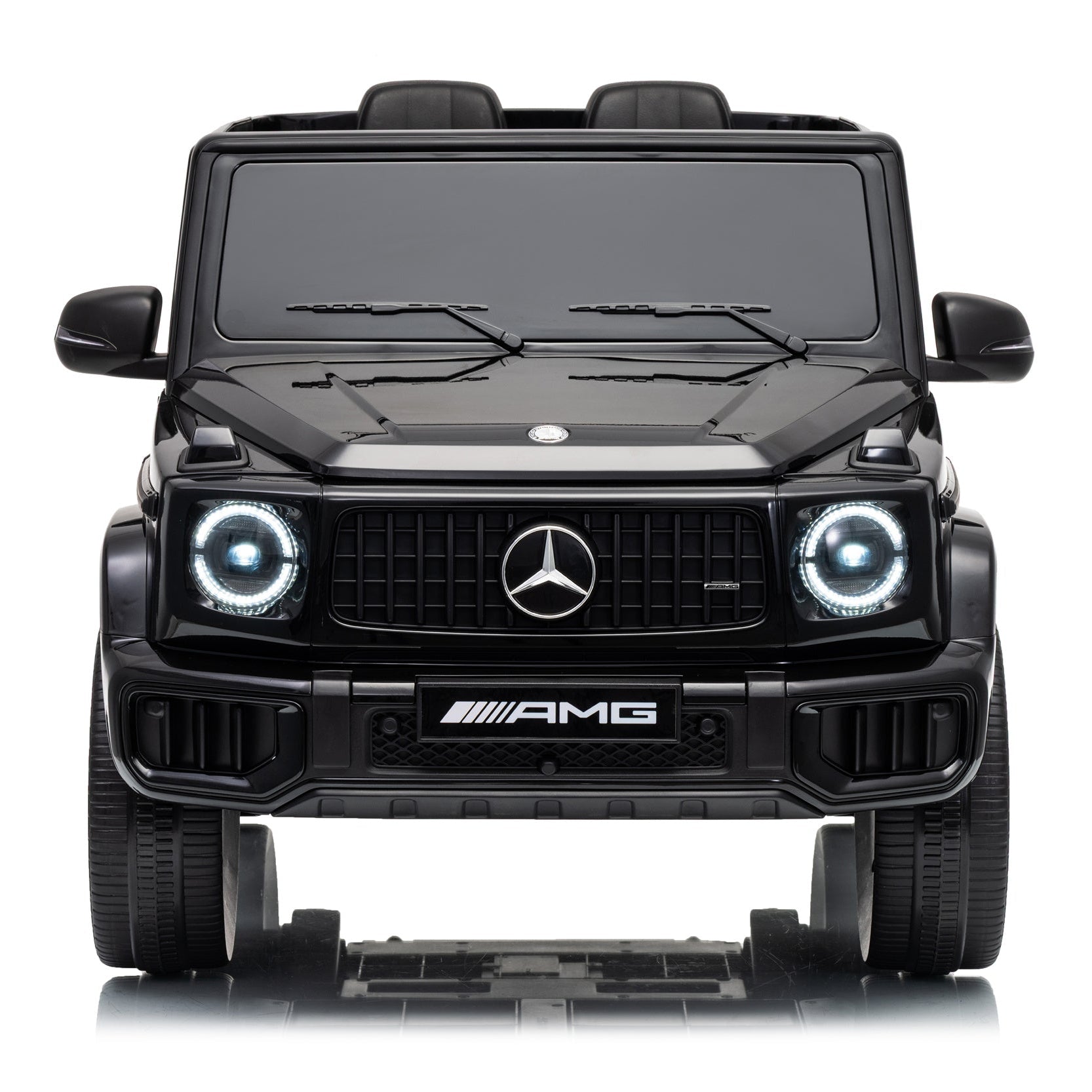 Black Mercedes-Benz G-Class style vehicle toy or replica shown from the front on a white studio background, with illuminated circular headlights, a large grille, and AMG badge.