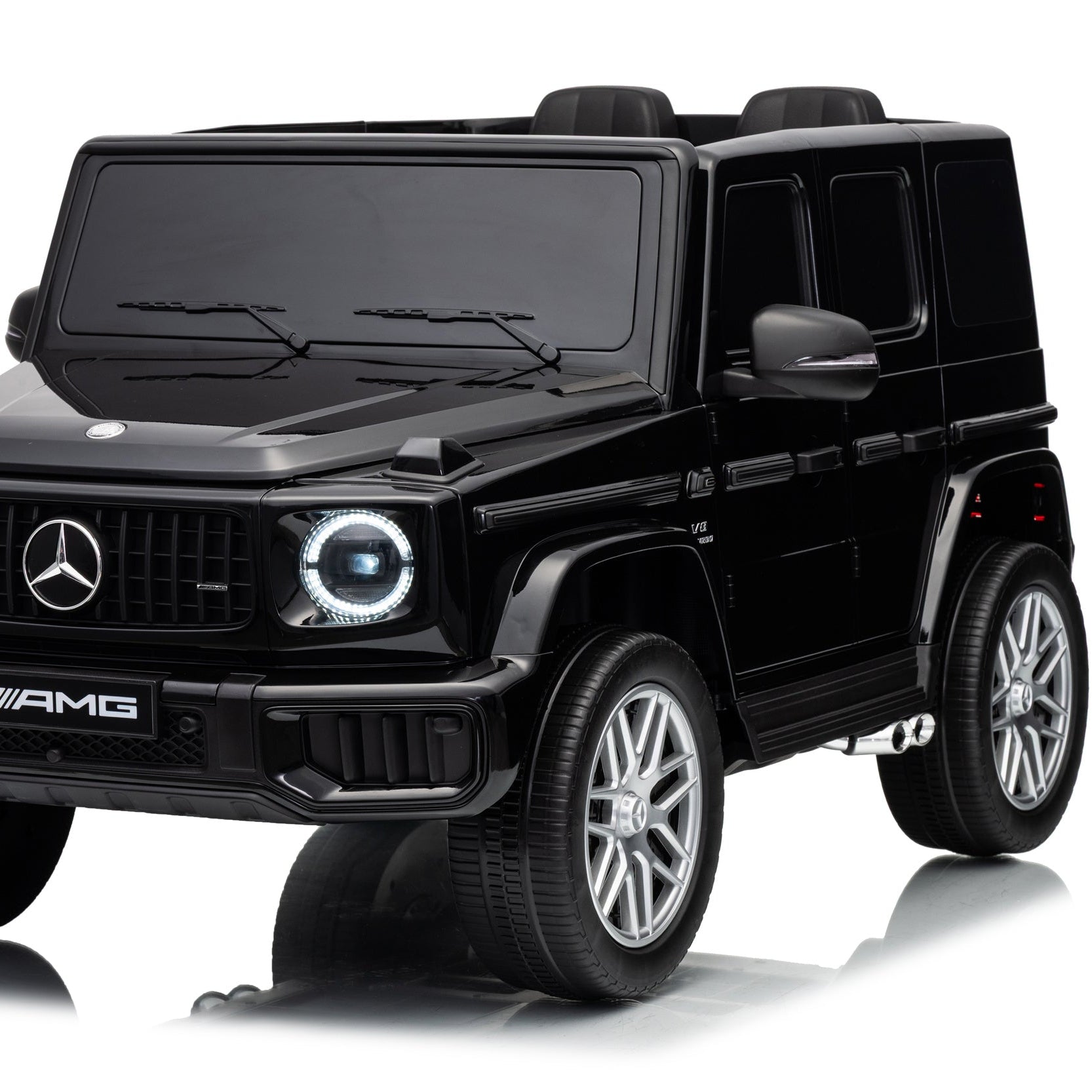 A black Mercedes-Benz AMG G-Class toy car with silver multi-spoke wheels, shown from a three-quarter front angle on a white background with a reflection.