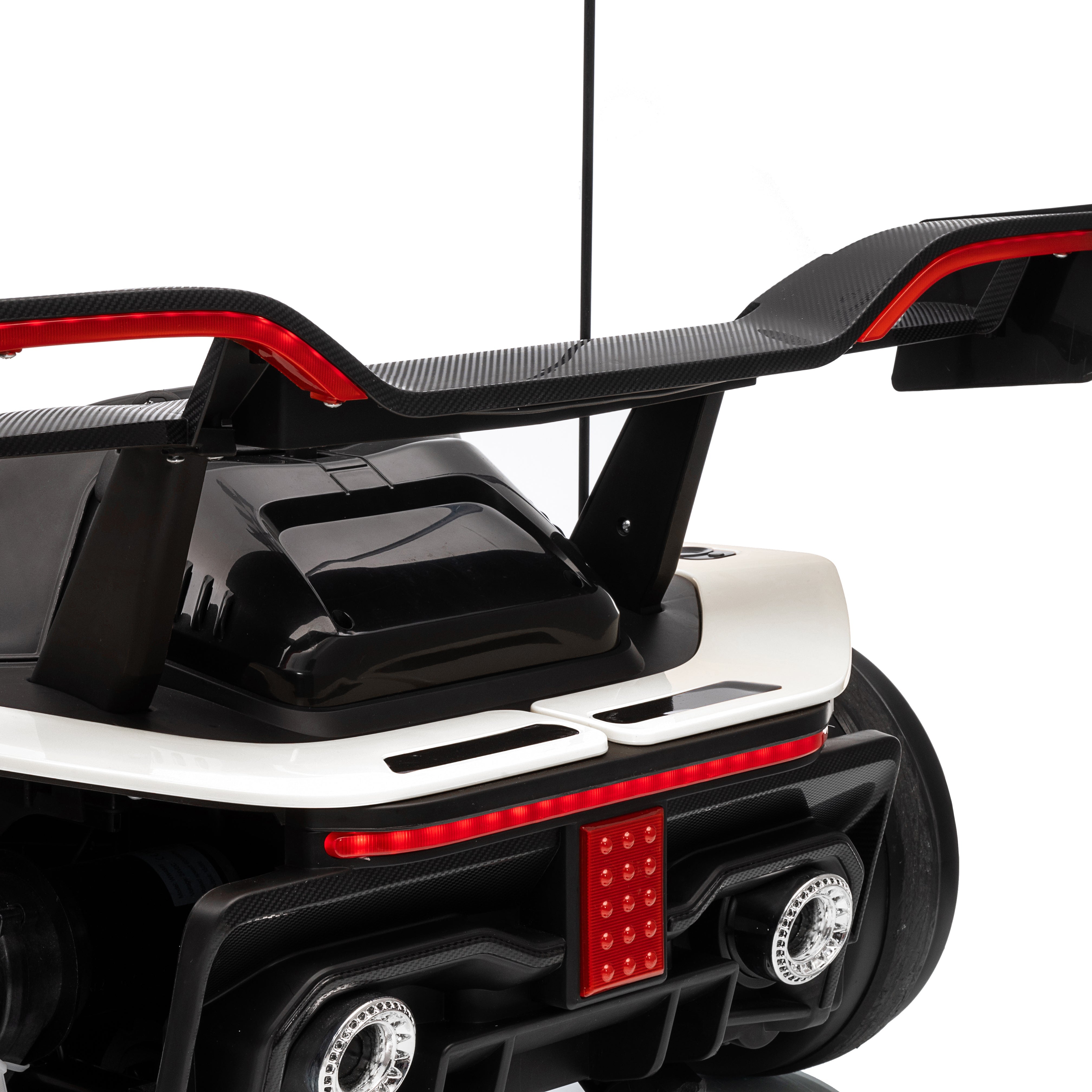 Close-up of a black and white toy car with a checkered flag design on a white background