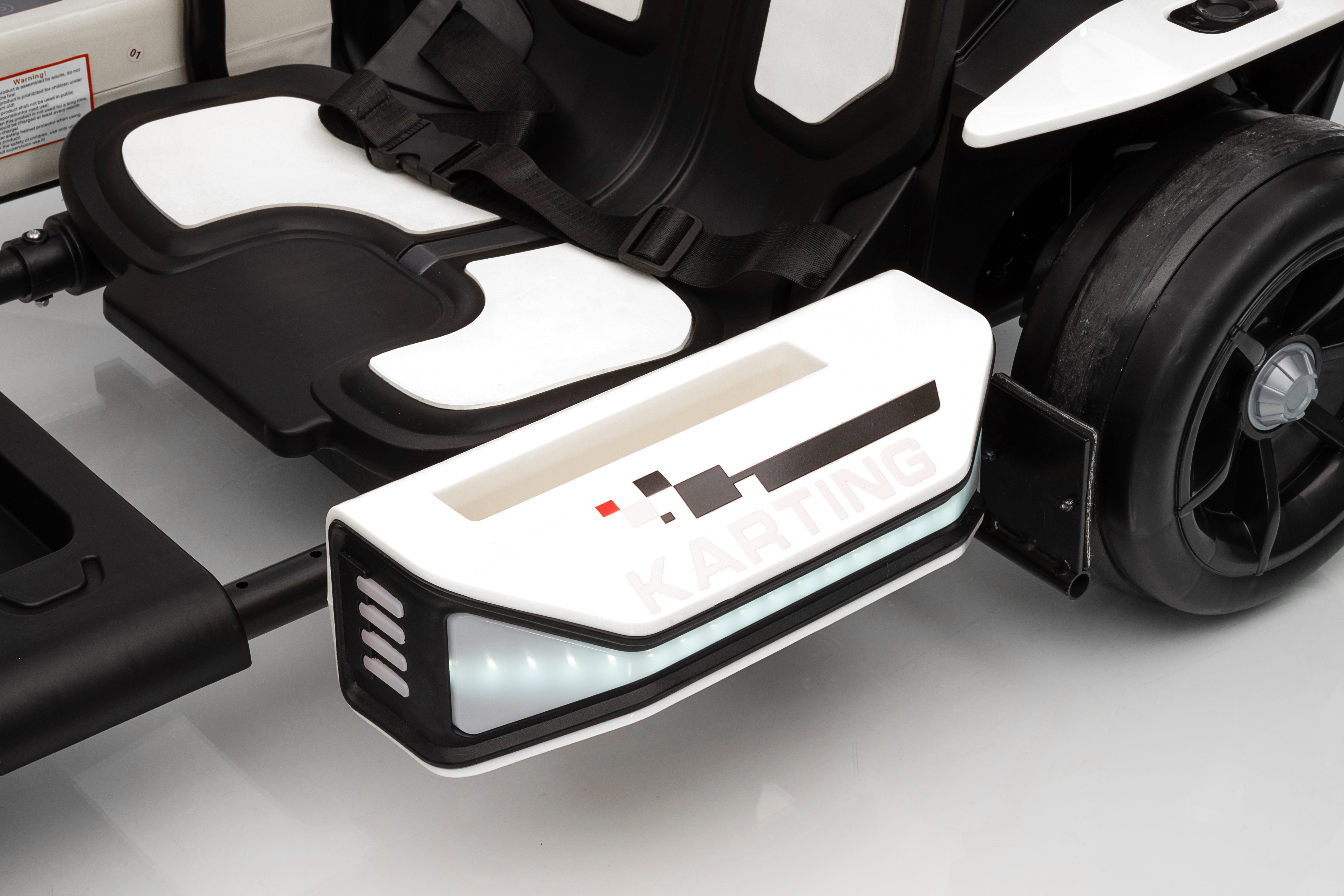 Close-up of a vehicle seat with a charging port cover on a white surface
