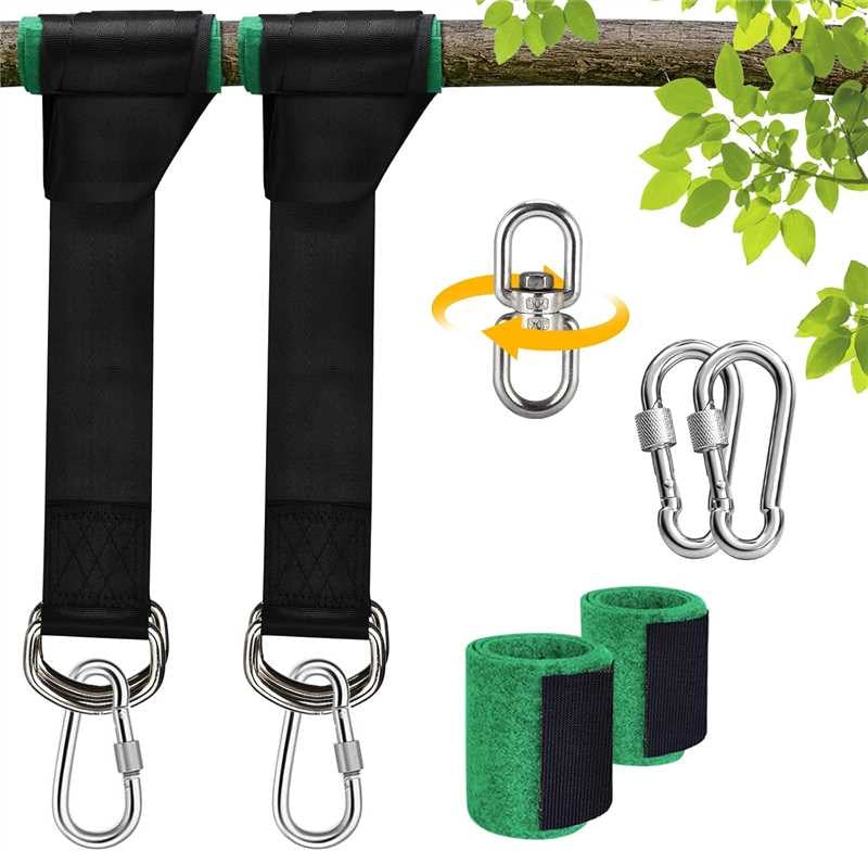 Tree swing straps with carabiners and wrist straps on a branch with leaves.