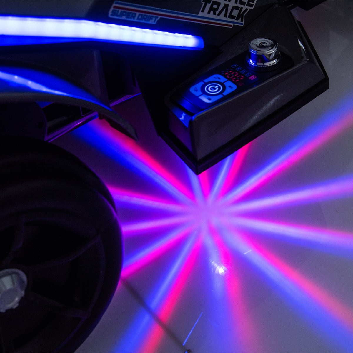 Close-up of a vehicle body panel with an integrated control module and a bright LED light bar, casting blue and pink laser-like light beams onto a dark surface.