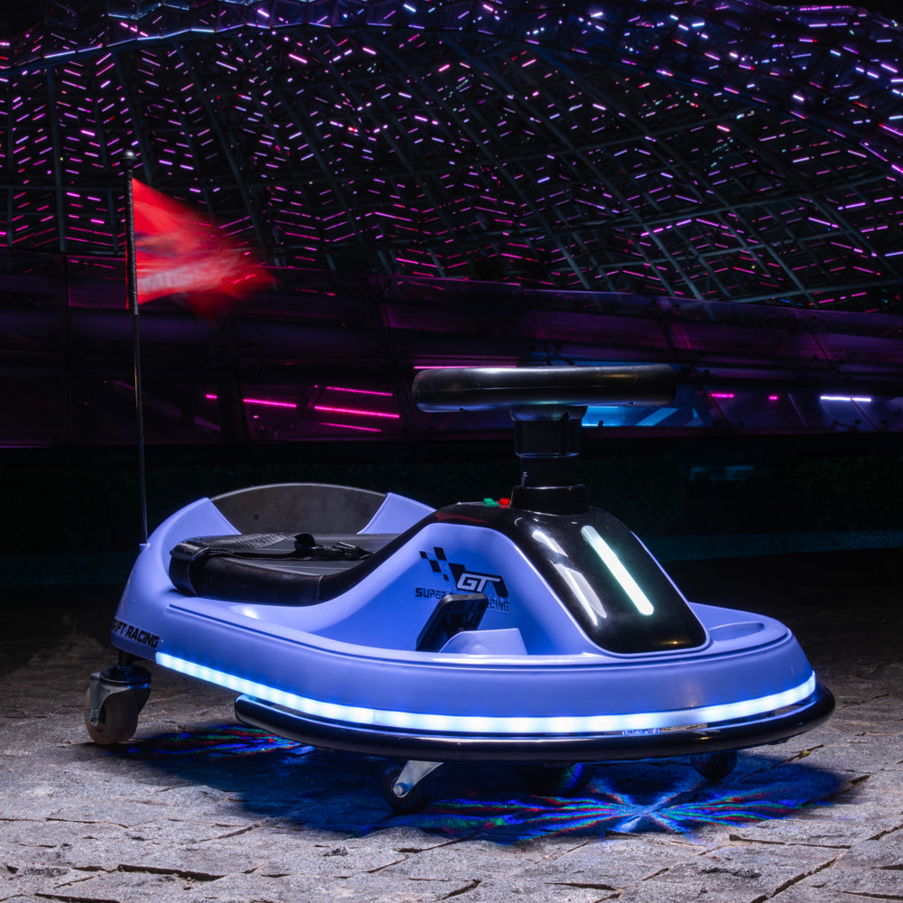 A light blue and black electric bumper car with glowing white LED strip lights, parked on a stone floor under a dark, illuminated event ceiling.