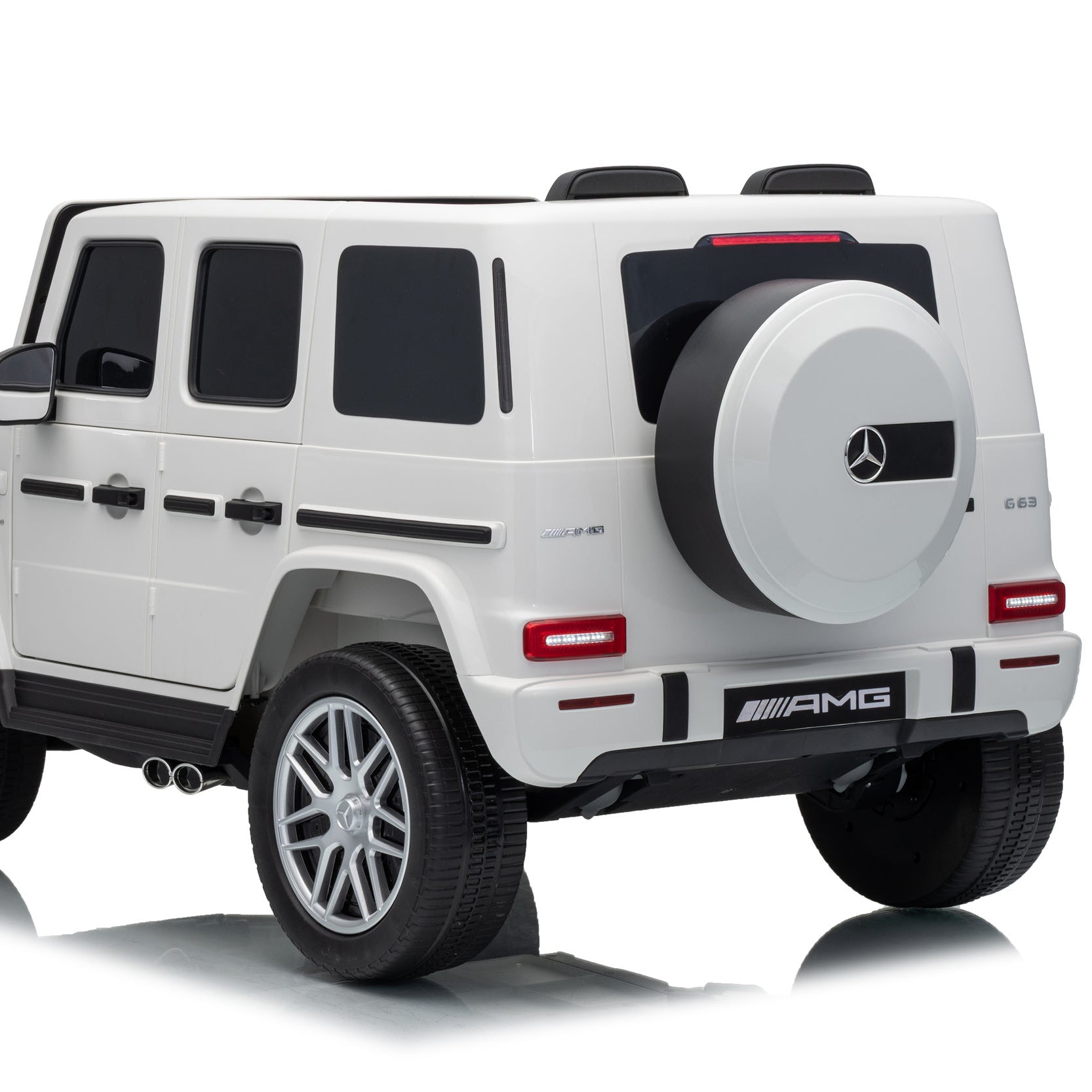 A white Mercedes-Benz AMG G-Class style toy SUV with black trim, silver wheels, and a spare tire mounted on the back, shown on a clean white studio background.