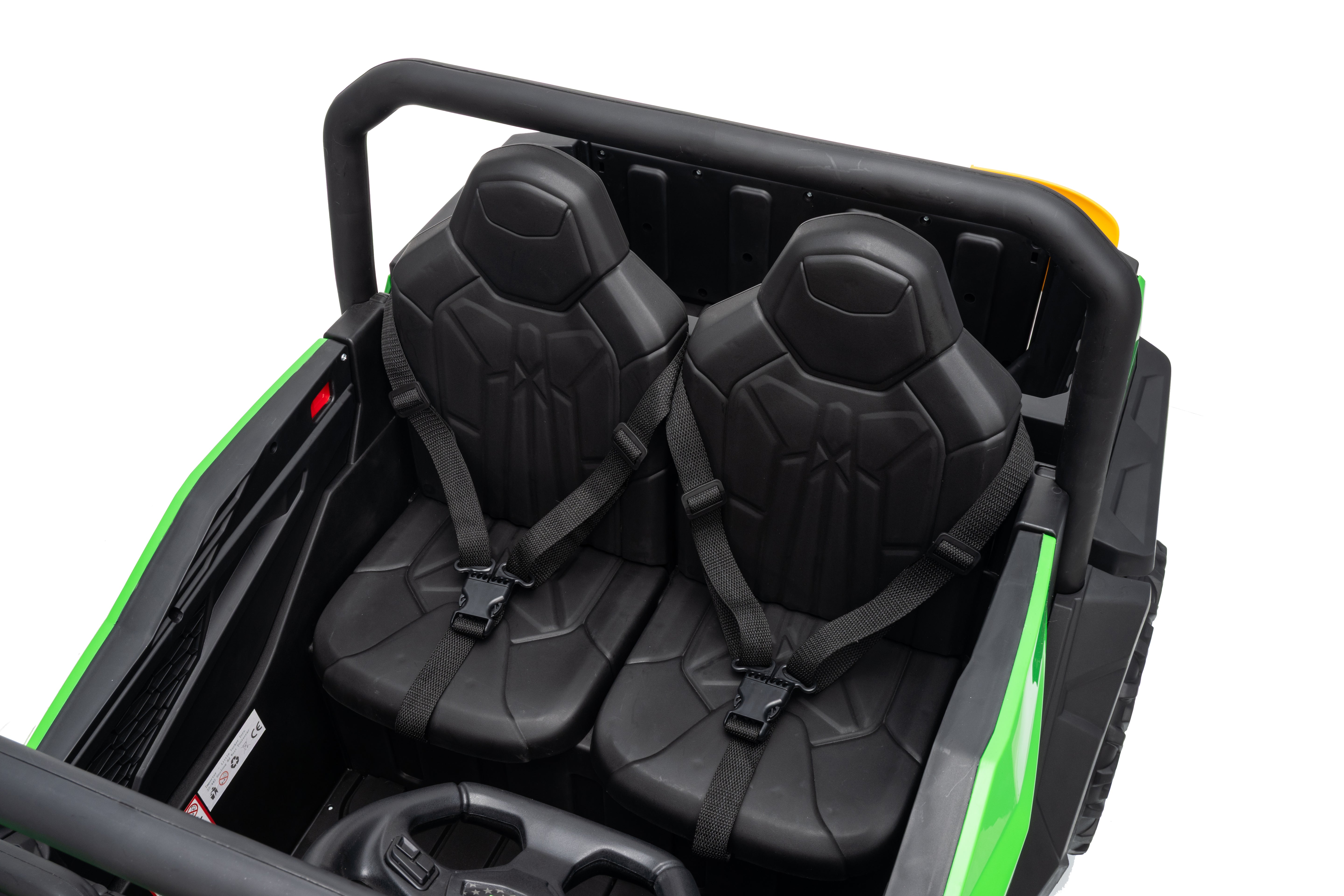 Two black seats inside a green and black four-wheeler on a white background