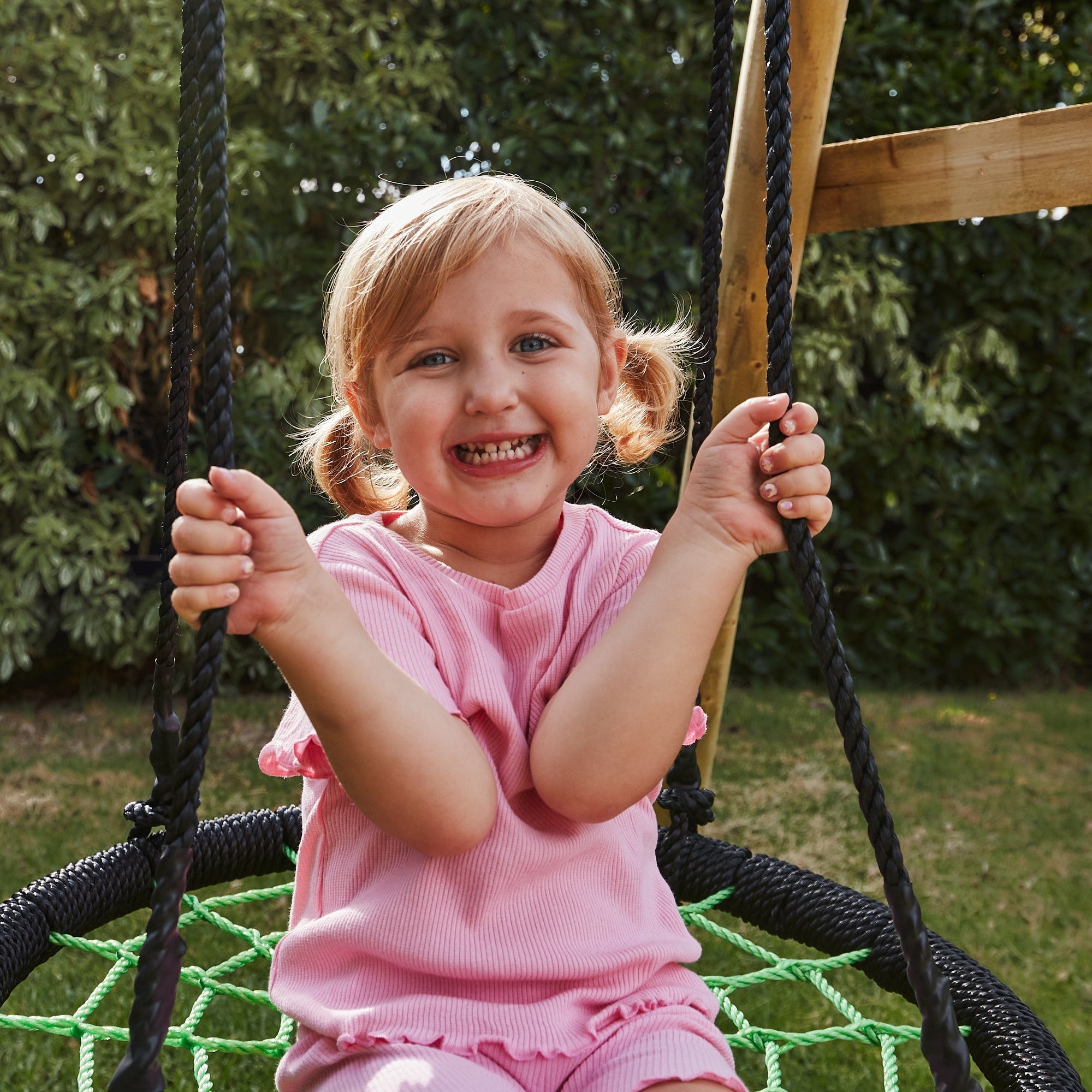 Child on a swing set in a garden