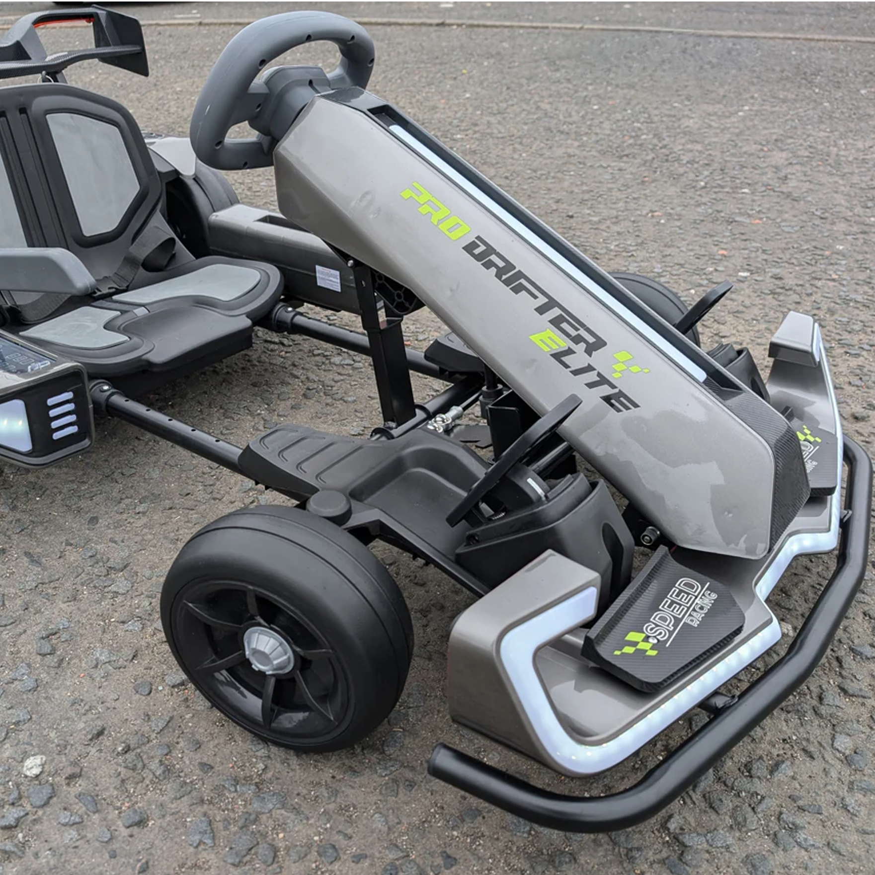 Grey and black go-kart on a paved surface