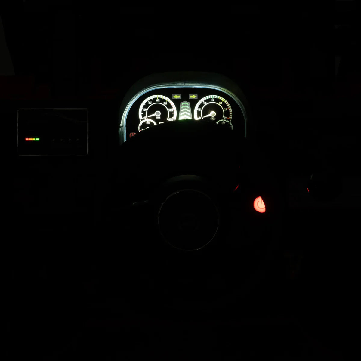 Car dashboard with illuminated gauges in a dark setting
