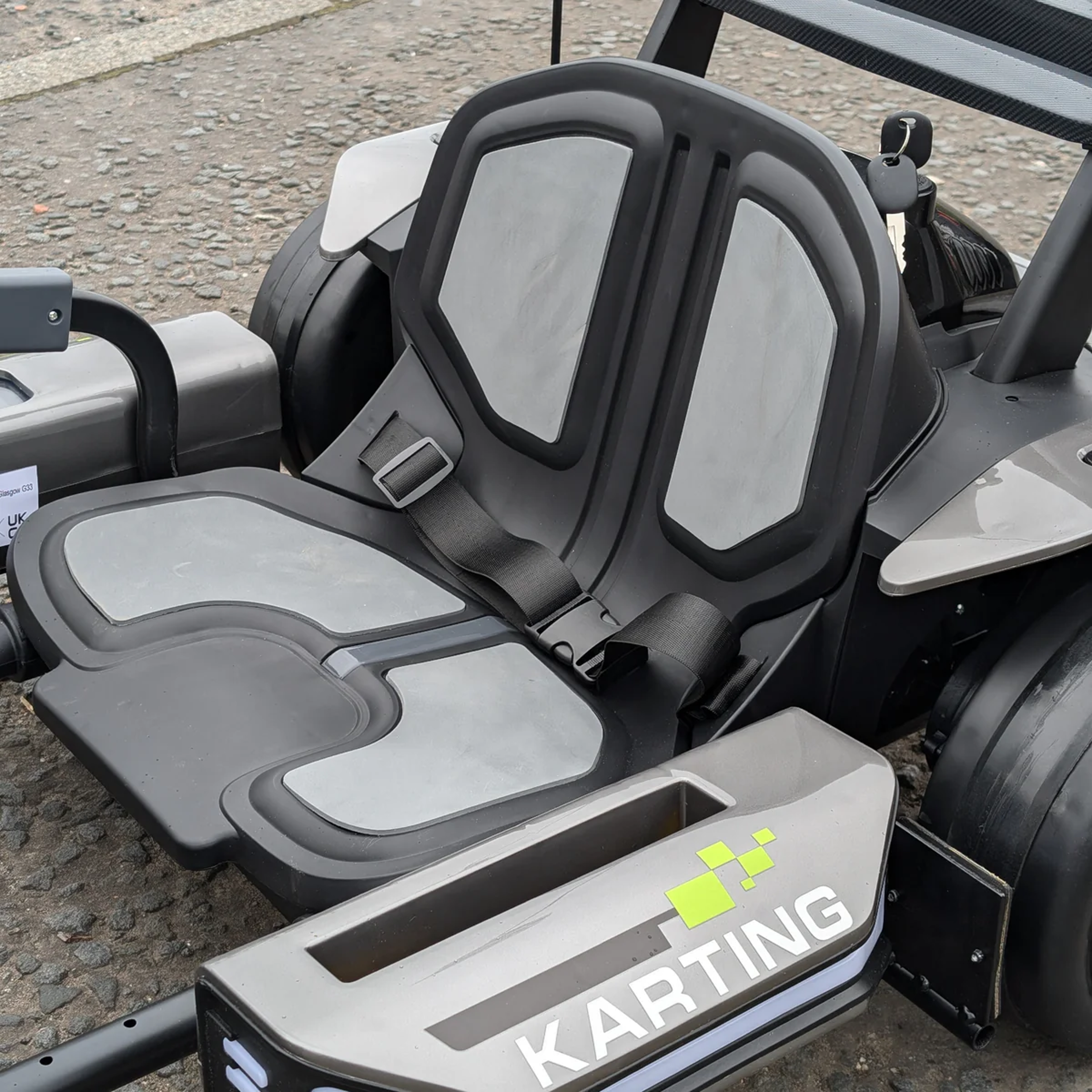 Close-up of a karting seat with 'Karting' branding on a kart.