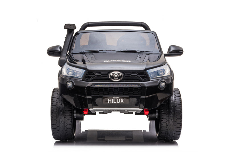Front-right perspective of the Toyota Hilux 4WD kids’ electric ride-on highlighting off-road wheels and bumper.
