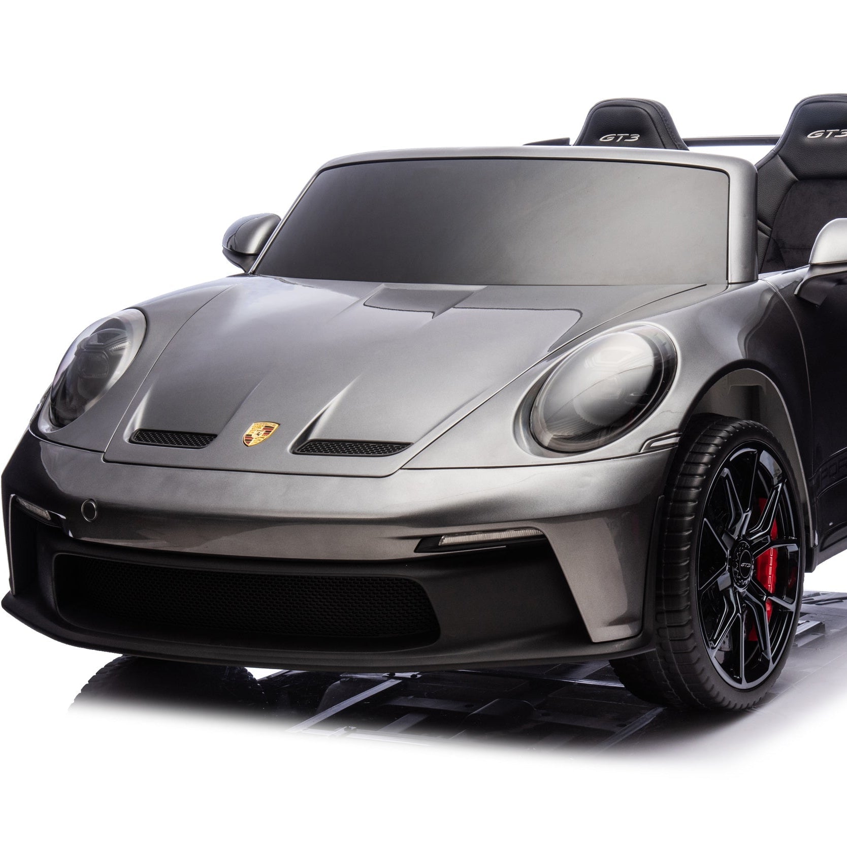 Black toy car with Porsche logo on a white background