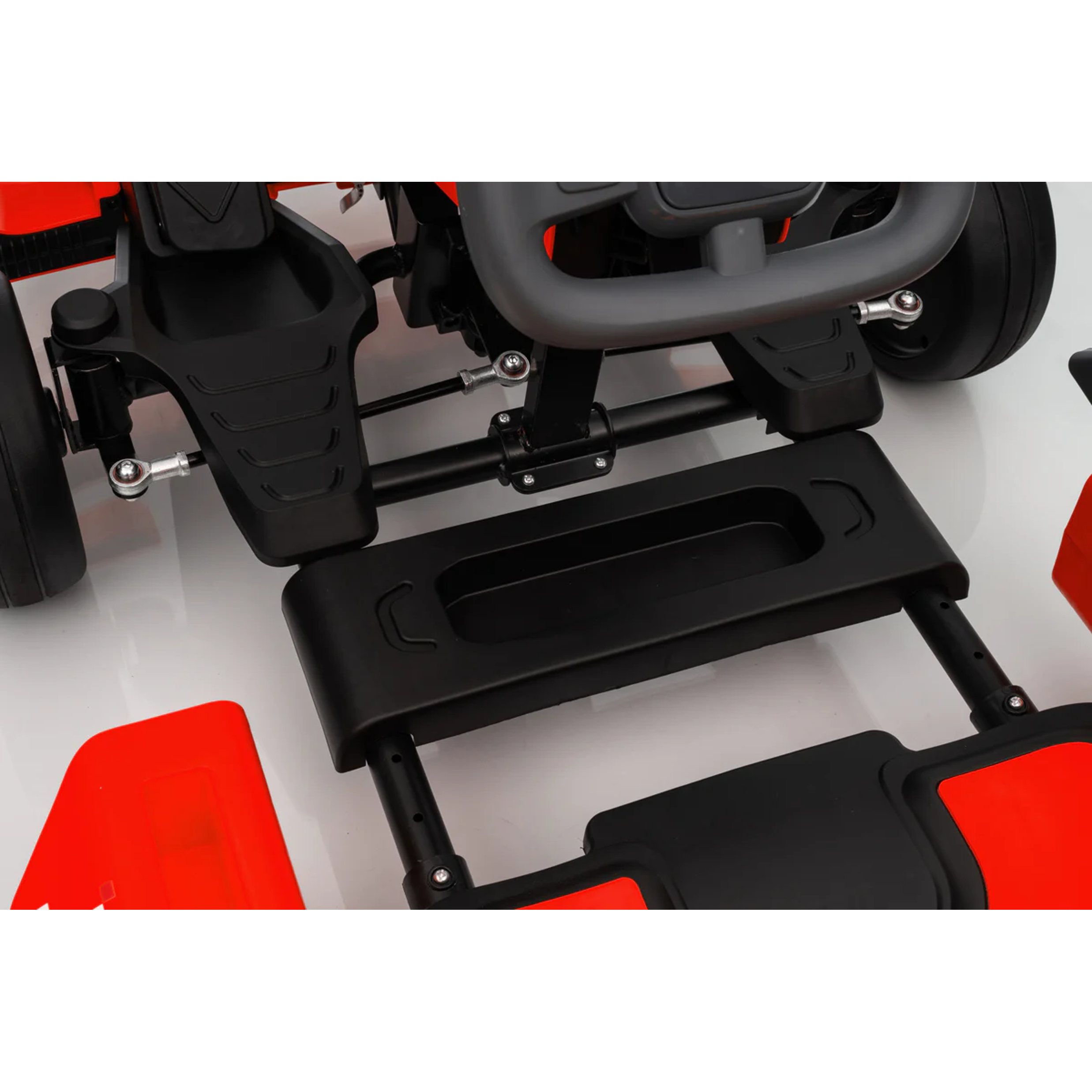 Close-up of a black and red vehicle seat and footrest on a white background