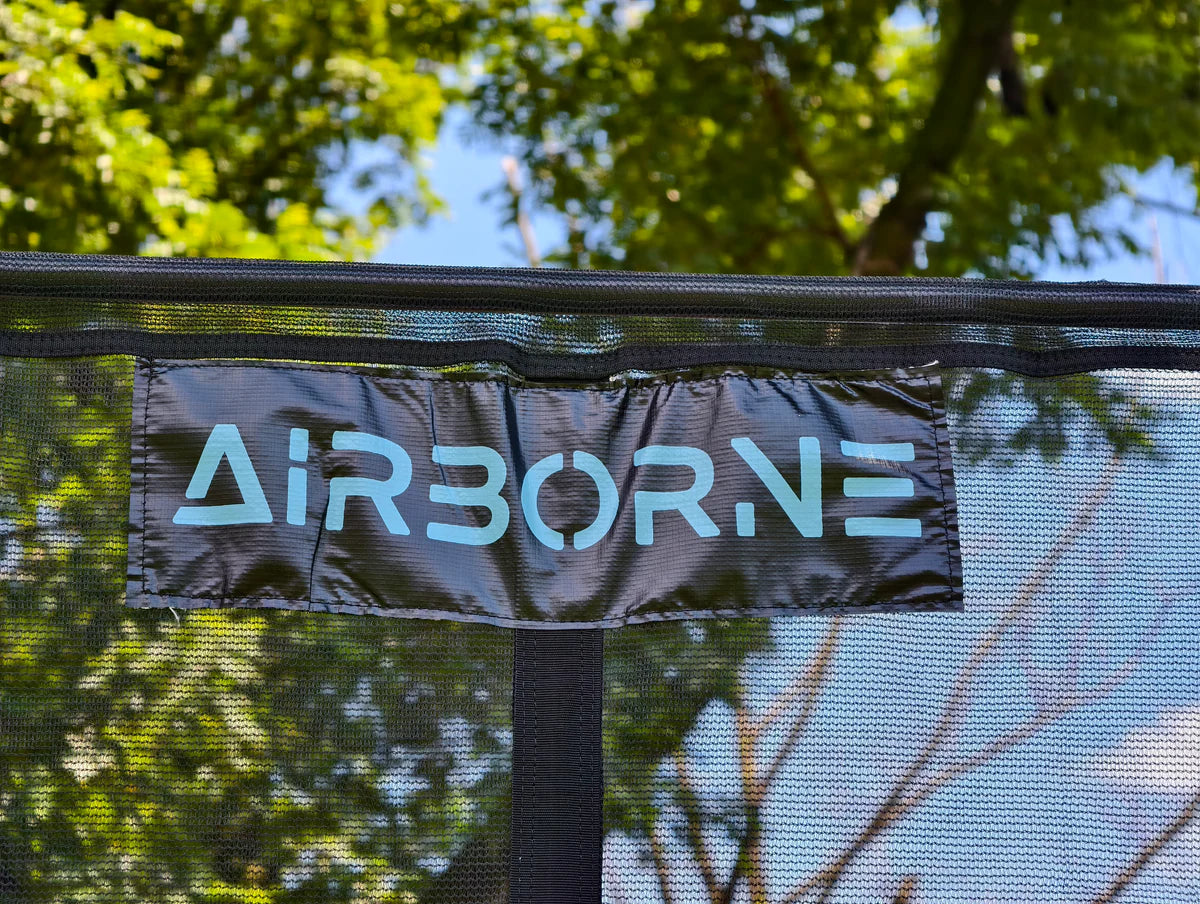 Trampoline with 'AIRBORNE' branding against a natural background