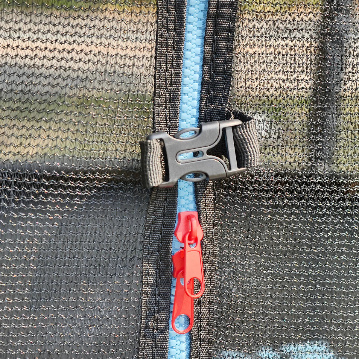 Close-up of a mesh bag with a blue strap and red tag on a camouflage background